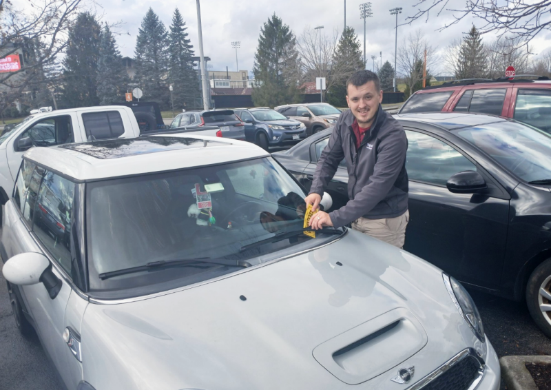 Parking enforcement officer Jimmy Griggs hands out a golden ticket.